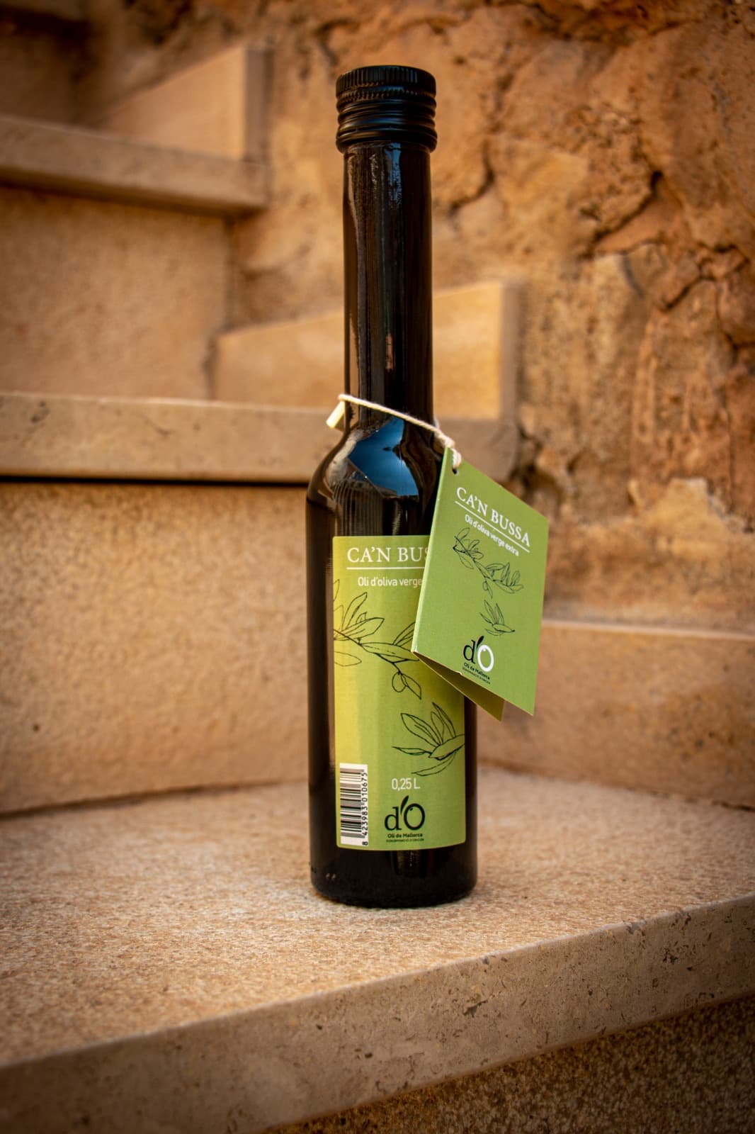 Oli de Mallorca extra virgin olive oil on a stone staircase