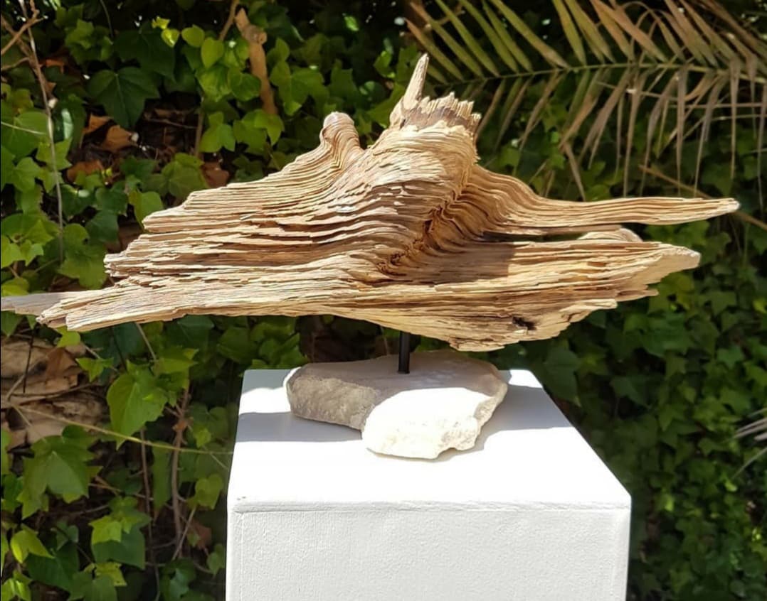 Funeral urn for pets made on textured wooden log.