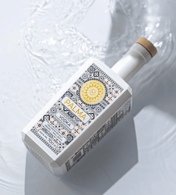 Bottle of Palm Vodka over water